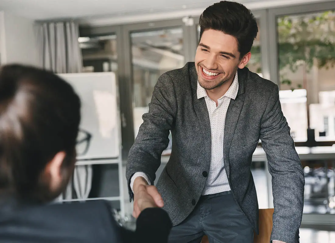 Join-Our-Team-Man-During-an-Interview-Getting-Up-to-Shake-the-Hand-of-Their-Future-Boss