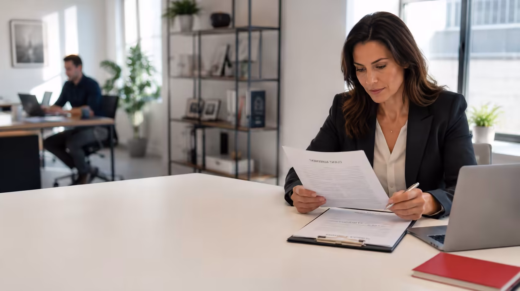 Consultant reviewing a client agreement and project materials for professional liability insurance.